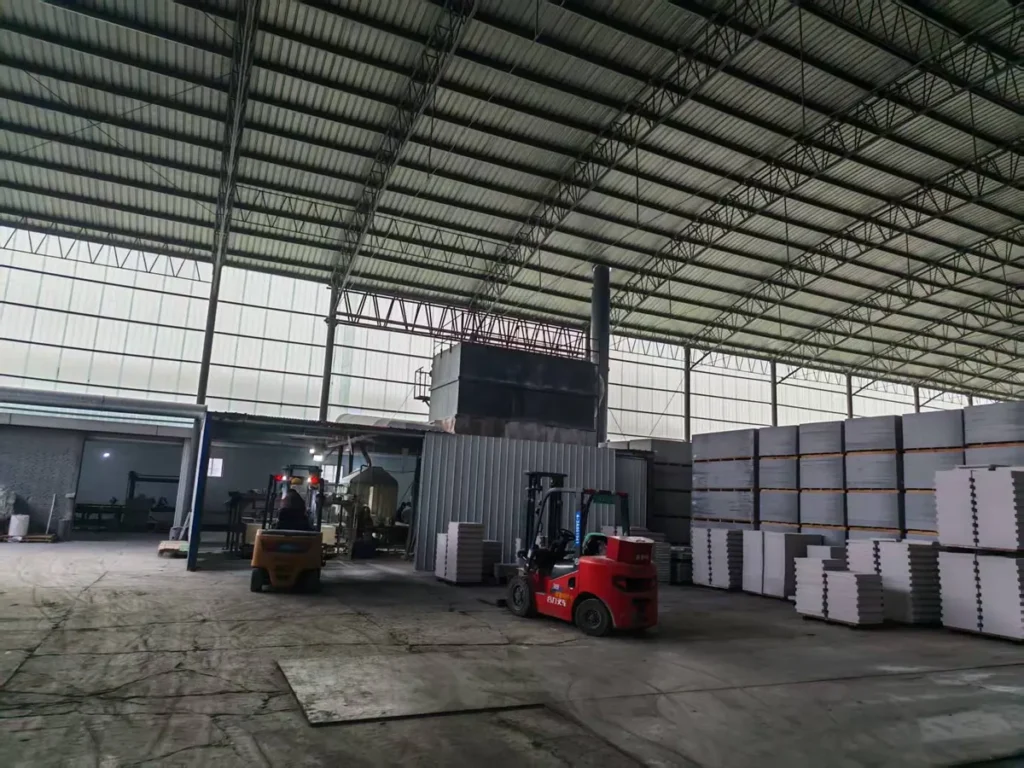 Forklift handling finished boards in the factory warehouse