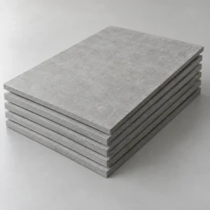 Stack of compressed fiber cement boards showing dense grey surfaces and square edges
