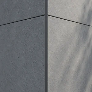 Close view of matte grey facade panel surfaces meeting at a neatly finished corner.