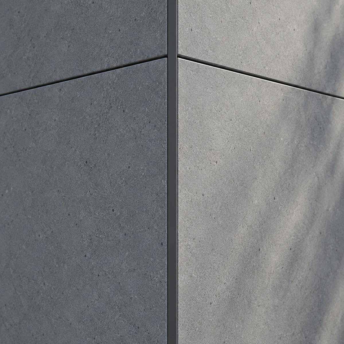 Close view of matte grey facade panel surfaces meeting at a neatly finished corner.