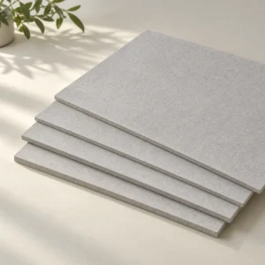Thin pale-grey ceiling board samples lying flat in a supported staggered stack.