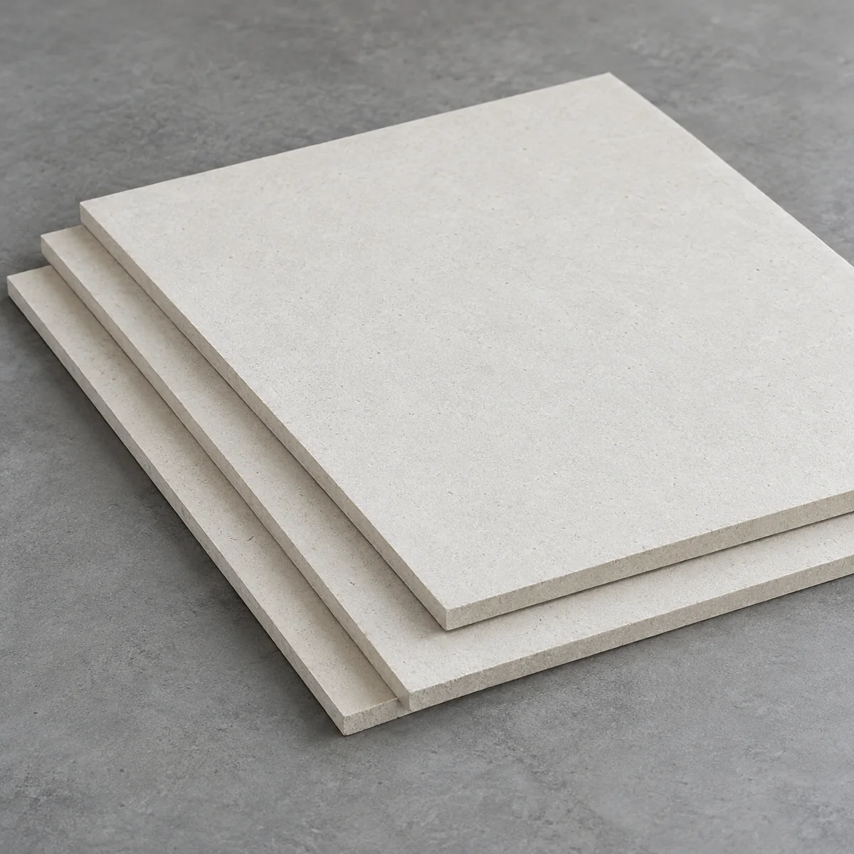 AI visualization of off-white calcium silicate board samples stacked on a grey surface.