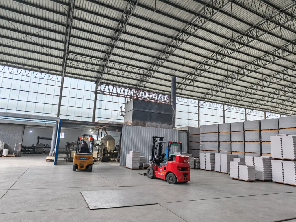Forklifts and stacked building boards in the factory warehouse
