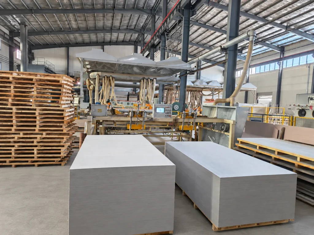 Finished fiber cement board stacks beside the production line